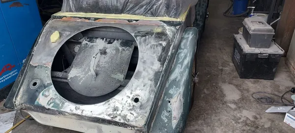 Detailed rear panel restoration and metal repair on the classic Morgan sports car