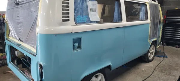 VW Type 2 camper side panel preparation with masking and primer applied