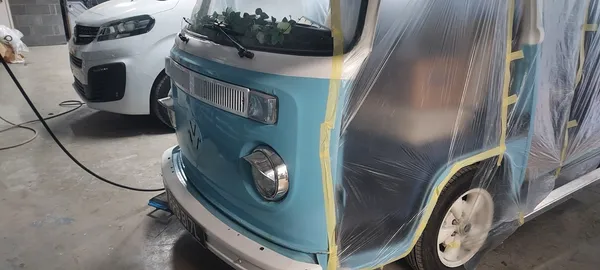 VW camper front end masked off and prepared for professional spraying