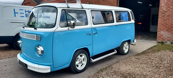 Restored VW Type 2 camper side profile in two-tone bright blue and white